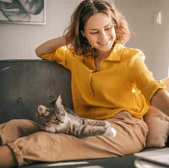 chilling on the sofa with her cat