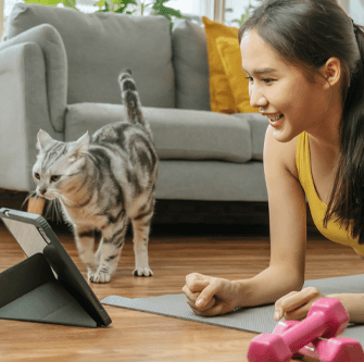 woman playing something on the tablet and the cat watch
