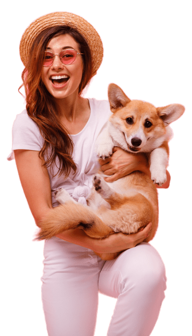 woman smiling while taking a photo with her dog