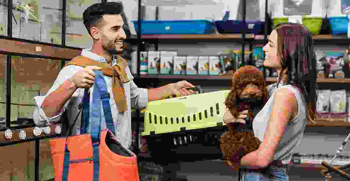 woman walking into a pet store with a welcoming owner